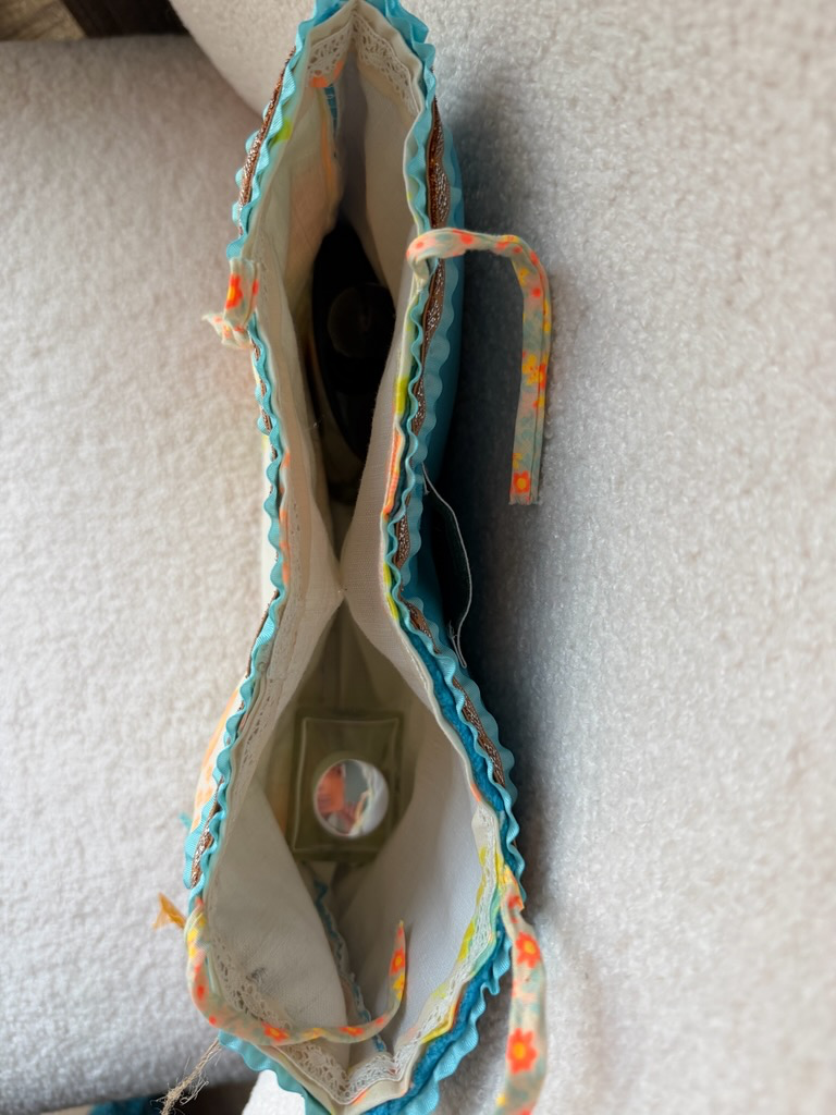 Intérieur pochette fait main Lyli Créarti, doublure ivoire avec poche à miroir et bordure plissée turquoise