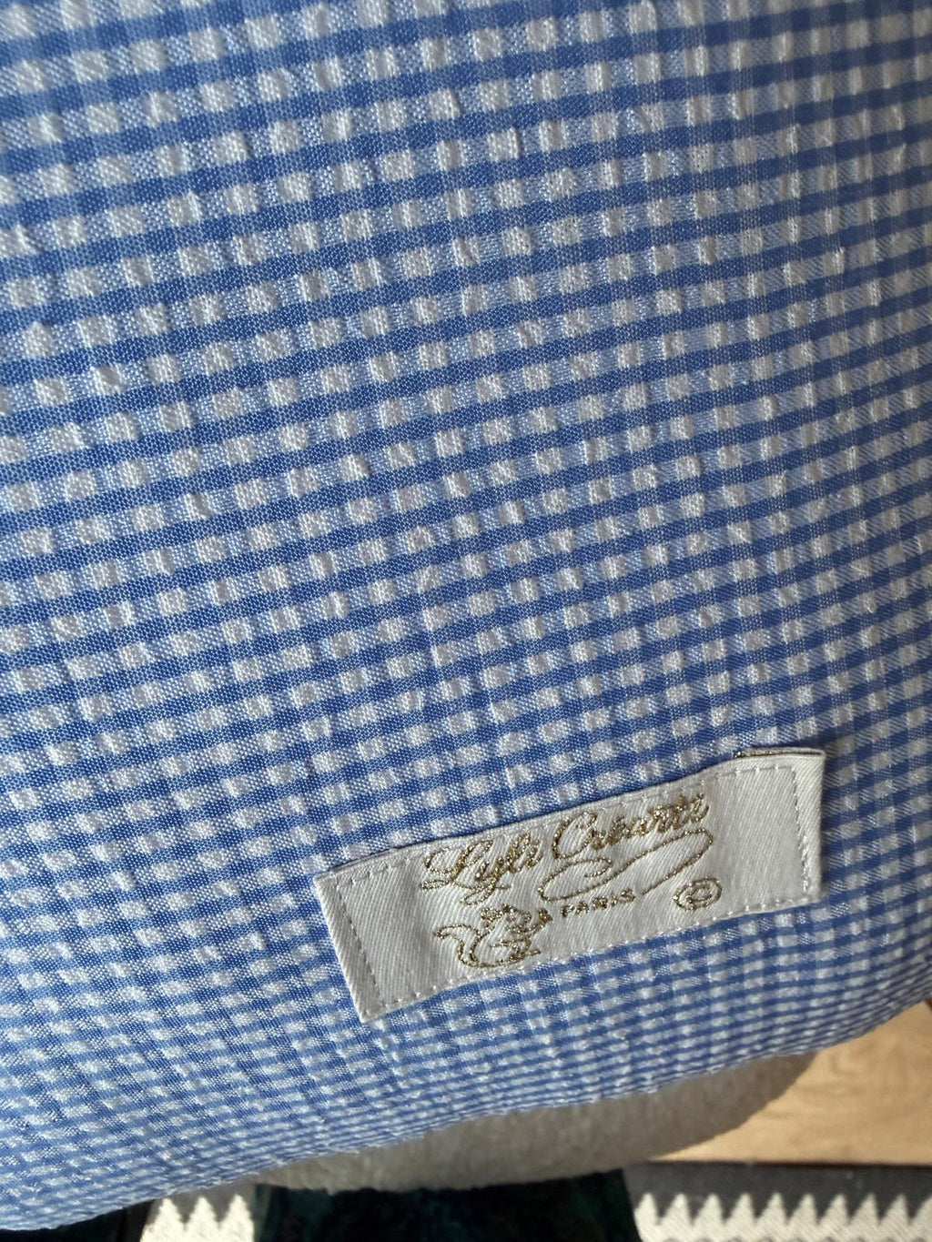 Doublure intérieure coussin fait main en vichy bleu avec étiquette de marque